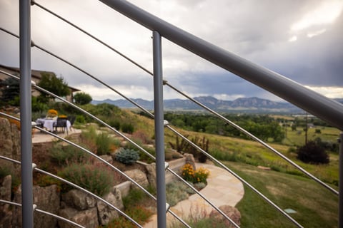 Residential landscape design back of house metal railing view