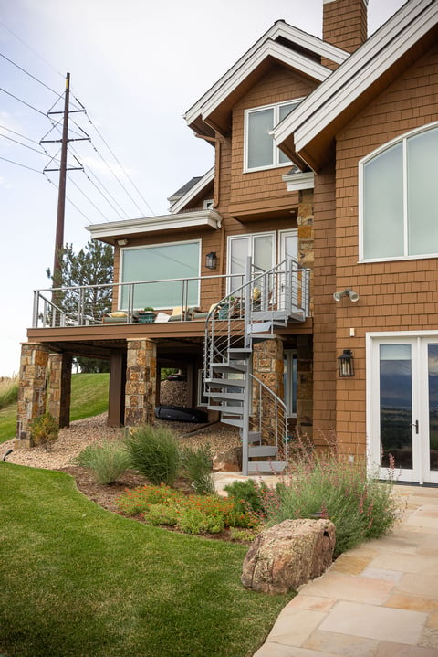 Residential landscape design back of house metal steps and railing