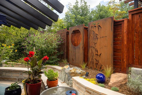Residential landscape design small backyard metal artwork 