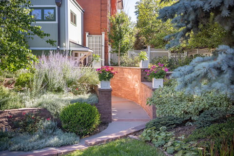 Residential landscape design with retaining wall and landscape beds