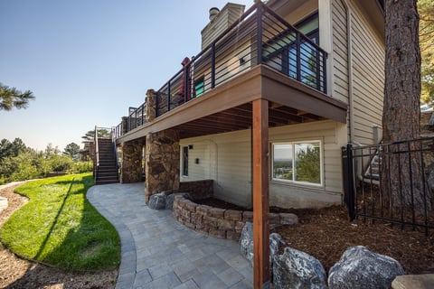 residential landscape design back deck with metal railing 