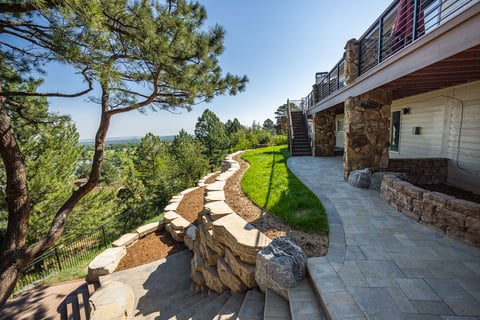 residential landscape design boulder retaining wall steps and deck 1
